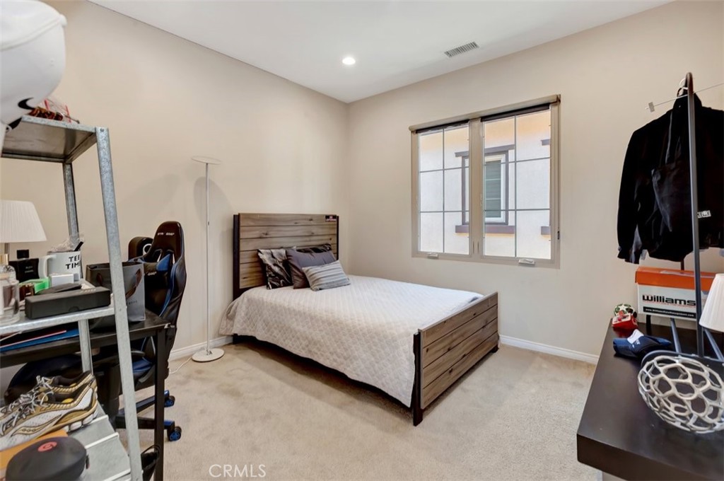 67 Hanging Garden Irvine, CA 92620 - Photo 16 of 23 a bedroom with a bed and wooden floor