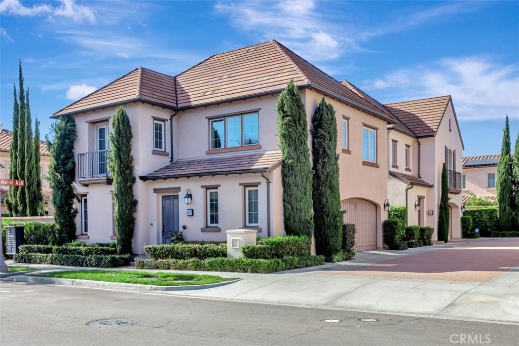 67 Hanging Garden Irvine, CA 92620 - Photo 2 of 23 a front view of a house with a yard