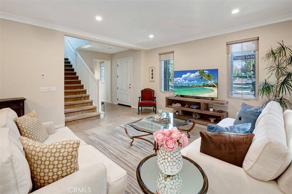 67 Hanging Garden Irvine, CA 92620 - Photo 3 of 23 a living room with furniture and a flat screen tv