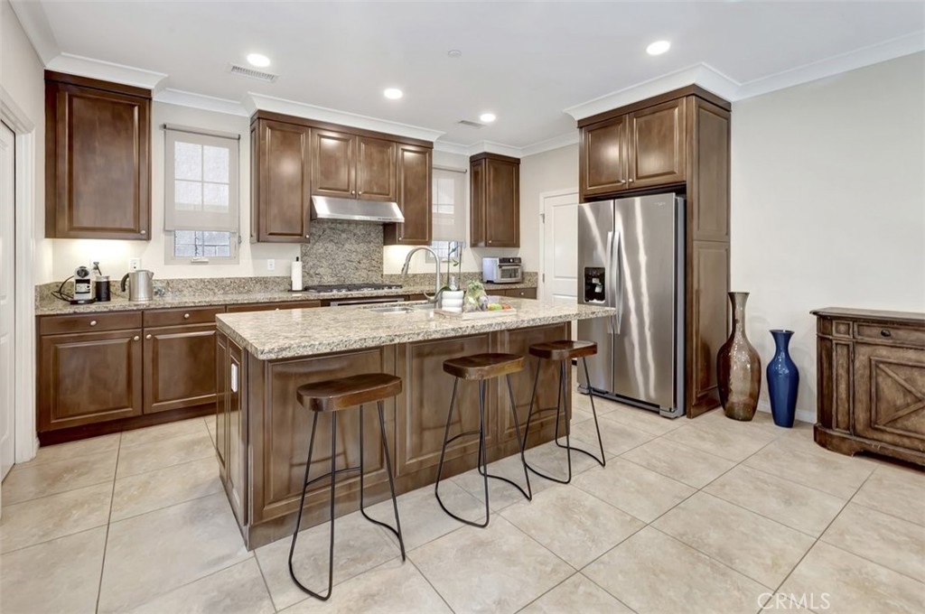 67 Hanging Garden Irvine, CA 92620 - Photo 5 of 23 a kitchen with stainless steel appliances a sink a stove a refrigerator and cabinets