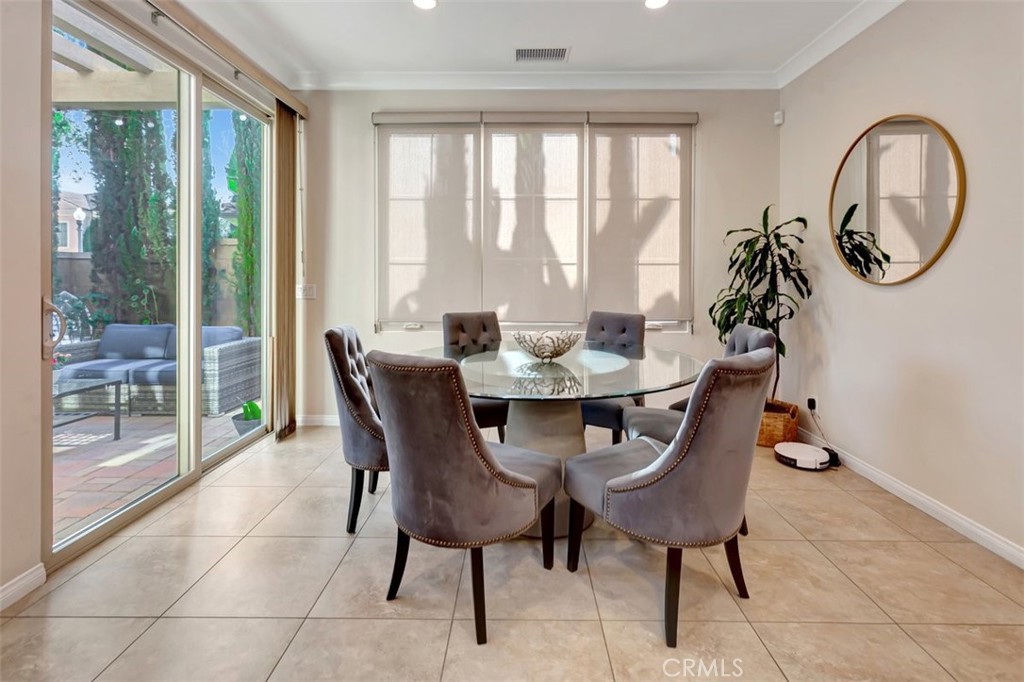 67 Hanging Garden Irvine, CA 92620 - Photo 8 of 23 a dining room with furniture a chandelier and a rug