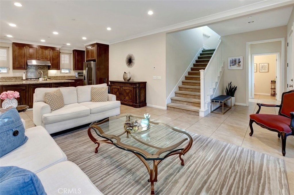 67 Hanging Garden Irvine, CA 92620 - Photo 9 of 23 a living room with furniture and kitchen view