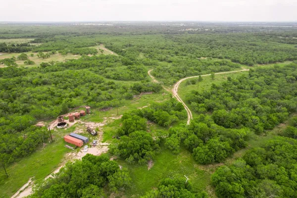 a view of a green field with an outdoor space