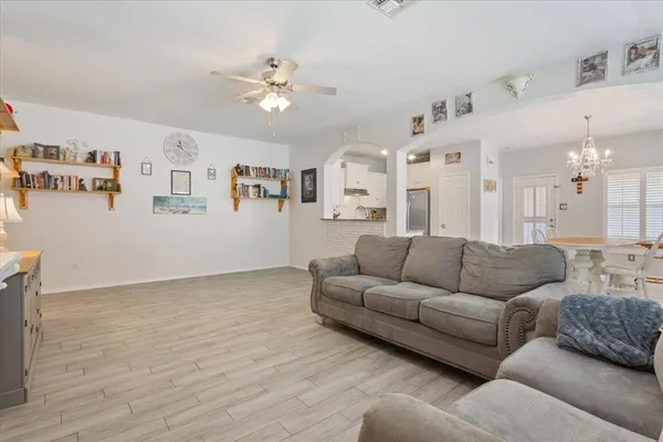 a living room with furniture and a chandelier