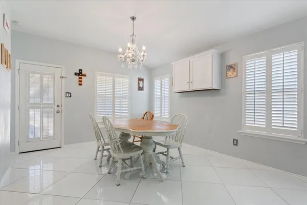 a view of a dining room with furniture and chandelier