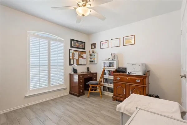 a view of a workspace with furniture and a window
