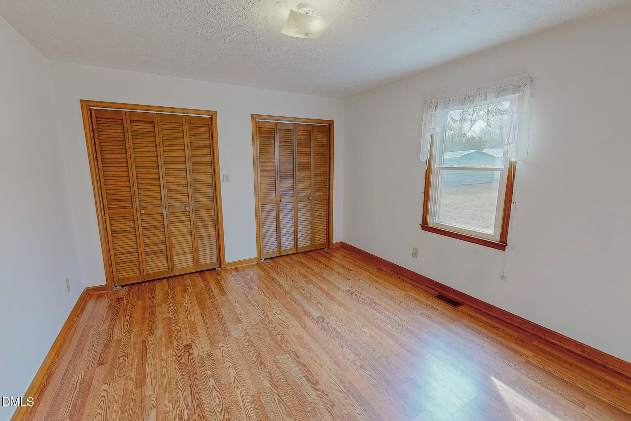 460 Medford Oakley Road Rougemont, NC 27572 - Photo 15 of 36 an empty room with wooden floor and windows
