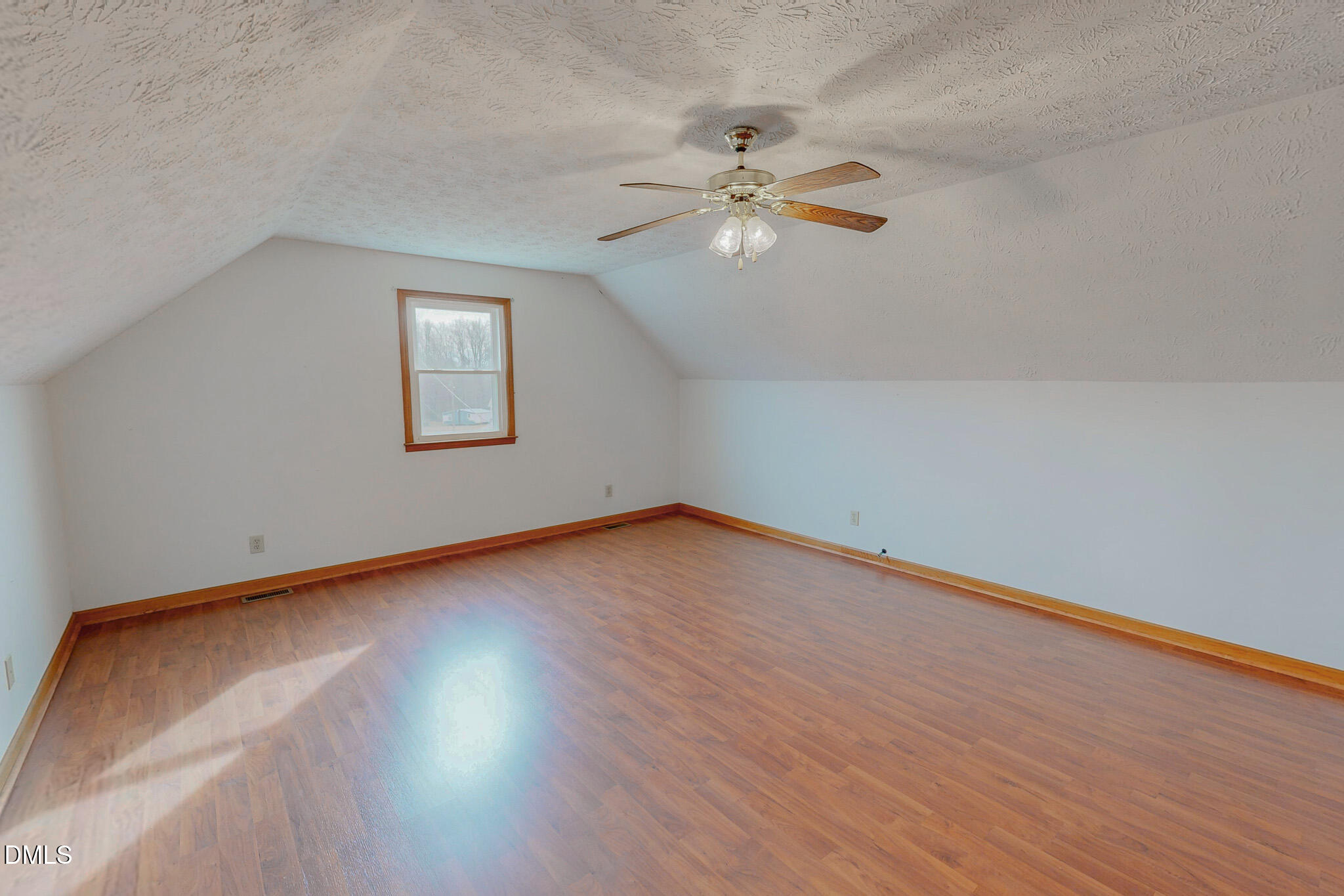 460 Medford Oakley Road Rougemont, NC 27572 - Photo 27 of 36 a view of an empty room with chandelier fan and wooden floor