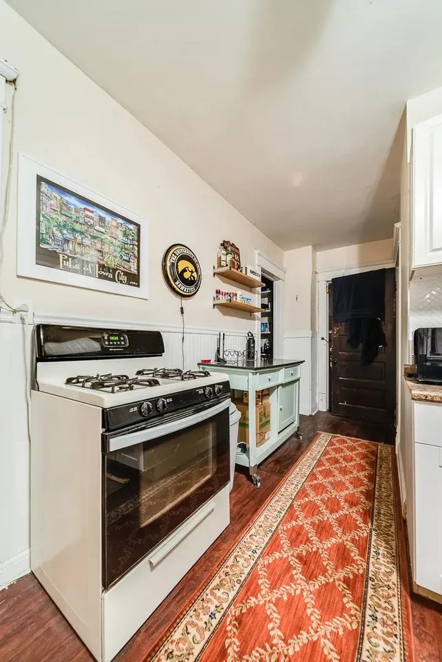 1308 West Byron Street, Unit G Chicago, IL 60613 - Photo 11 of 15 a kitchen with stainless steel appliances granite countertop a stove and a refrigerator