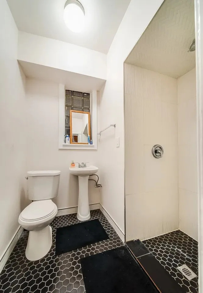 1308 West Byron Street, Unit G Chicago, IL 60613 - Photo 14 of 15 a bathroom with a toilet a sink and a mirror