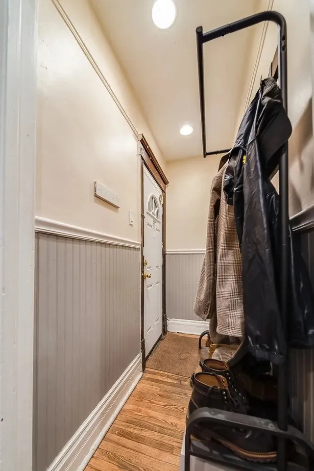 1308 West Byron Street, Unit G Chicago, IL 60613 - Photo 3 of 15 a view of a hallway with wooden floor and shoes