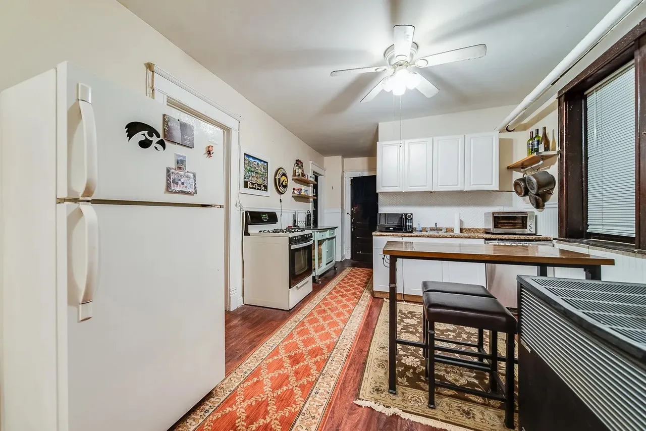 1308 West Byron Street, Unit G Chicago, IL 60613 - Photo 8 of 15 a kitchen with granite countertop a refrigerator stove top oven and sink