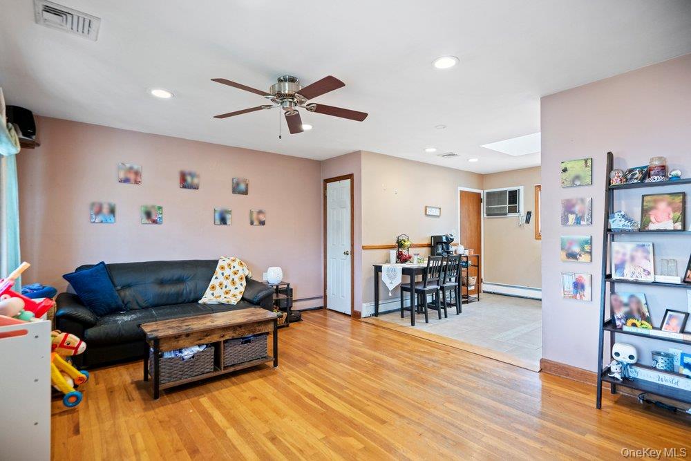 101 Sexton Road West Babylon, NY 11704 - Photo 6 of 33 a living room with furniture and wooden floor
