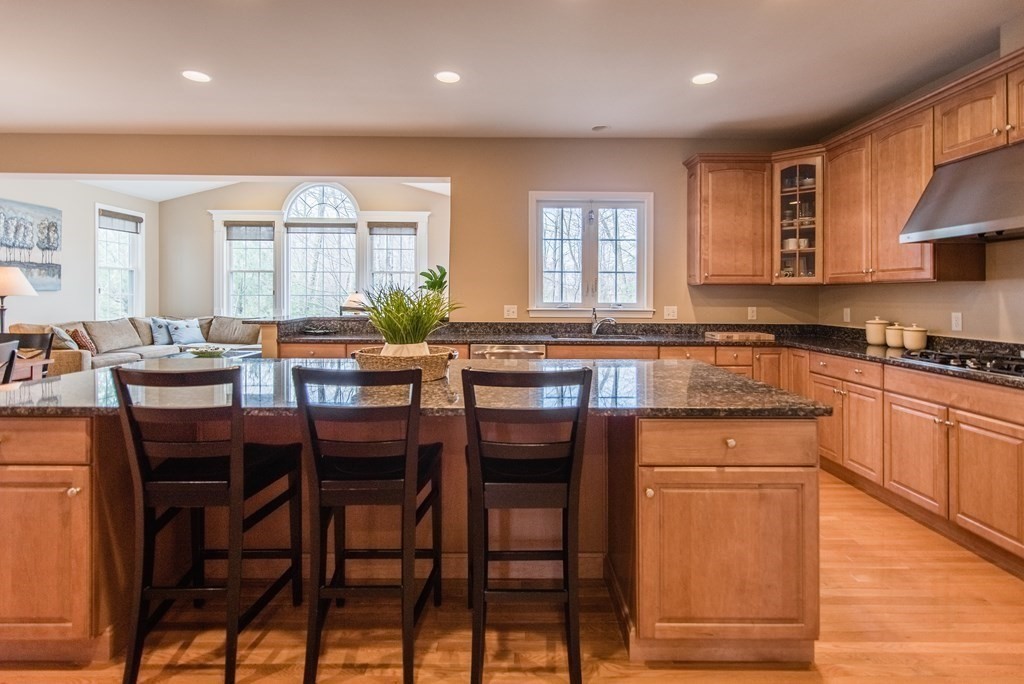 74 Canterbury Hill Road Acton, MA 01720 - Photo 12 of 37 a kitchen with stainless steel appliances granite countertop table chairs sink and cabinets