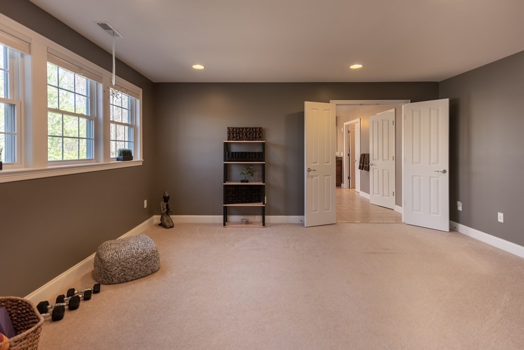 74 Canterbury Hill Road Acton, MA 01720 - Photo 25 of 37 an empty room with furniture and windows