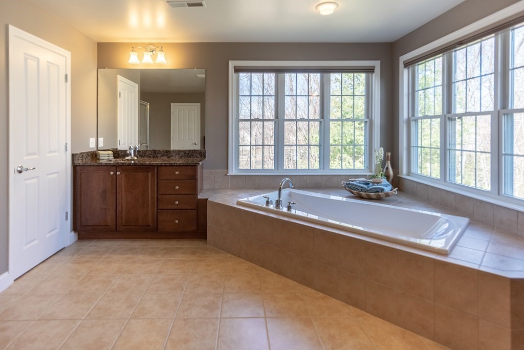 74 Canterbury Hill Road Acton, MA 01720 - Photo 26 of 37 a large spacious bathroom with a tub sink and mirror
