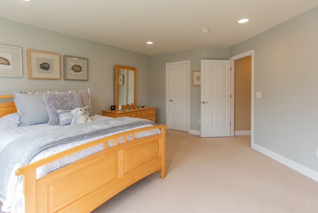 74 Canterbury Hill Road Acton, MA 01720 - Photo 29 of 37 a spacious bedroom with a bed and a lamp