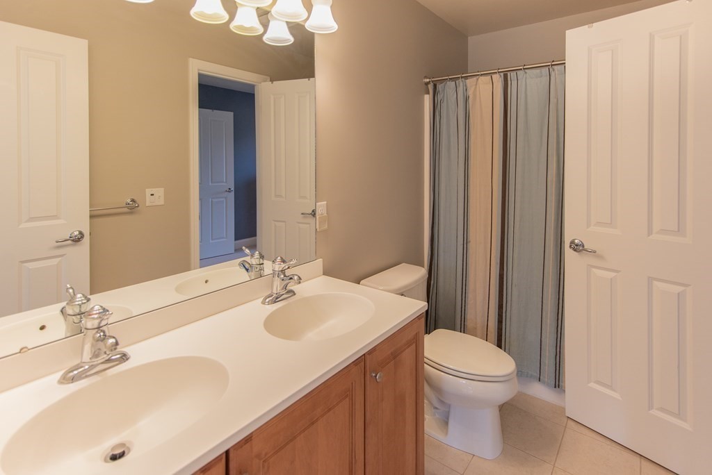 74 Canterbury Hill Road Acton, MA 01720 - Photo 30 of 37 a bathroom with a sink a toilet and shower curtain