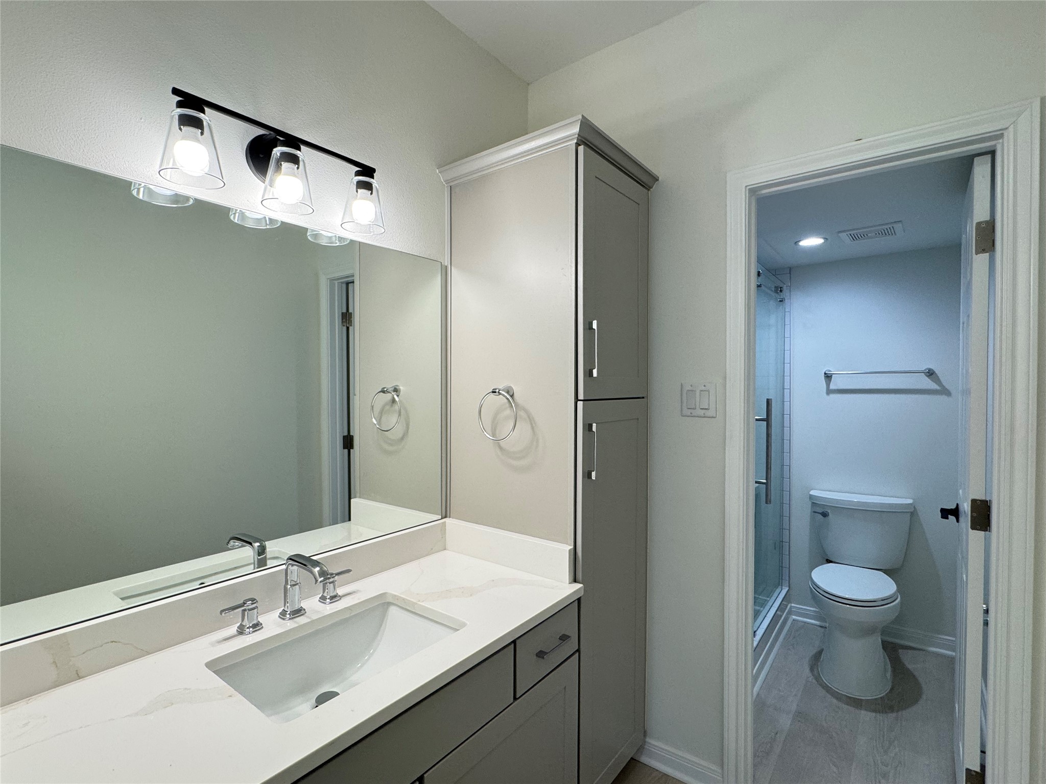 2100 Tanglewilde Street, Unit 626 Houston, TX 77063 - Photo 11 of 36 Primary bathroom vanity with linen storage on side, toilet and shower beyond