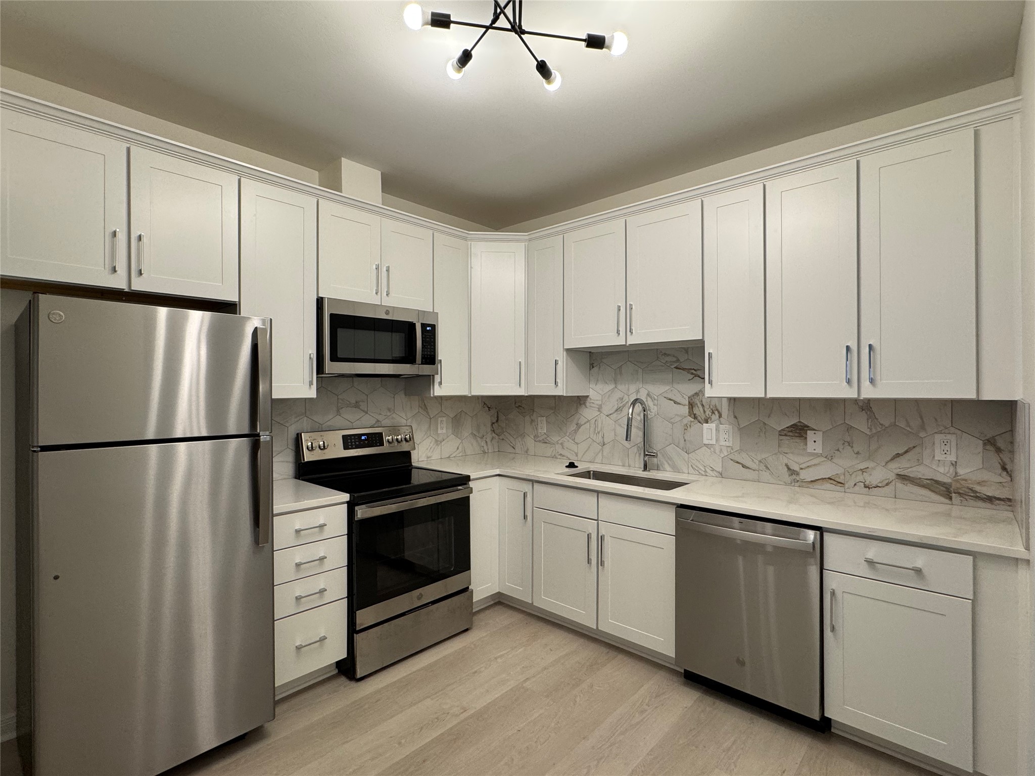 2100 Tanglewilde Street, Unit 626 Houston, TX 77063 - Photo 14 of 36 Gorgeous remodeled kitchen with modern lighting, tile work, and all stainless steel appliances