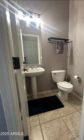 a bathroom with a sink a toilet a mirror and tub