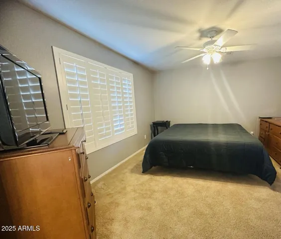 a bedroom with a bed and a flat tv screen
