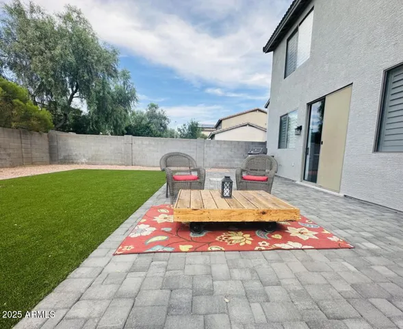 a view of a backyard with sitting area