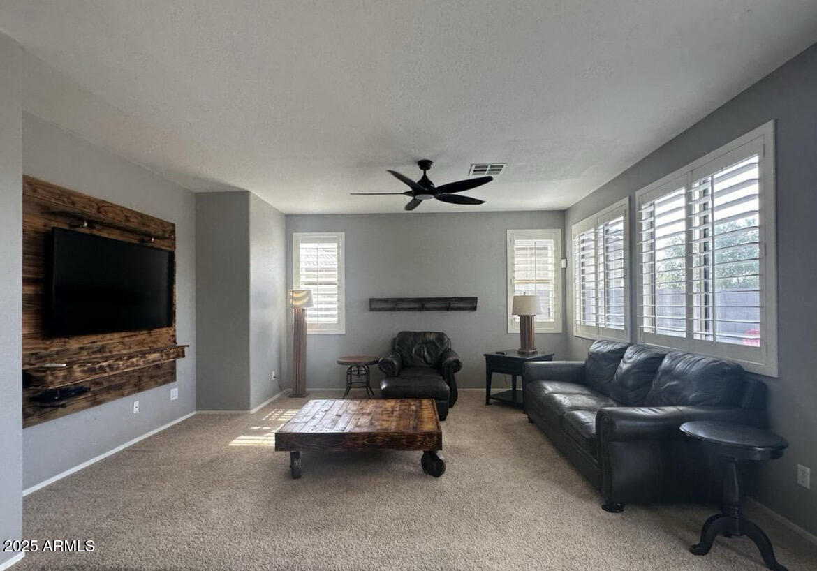 90 West Beechnut Place Chandler, AZ 85248 - Photo 4 of 32 a living room with furniture and a flat screen tv