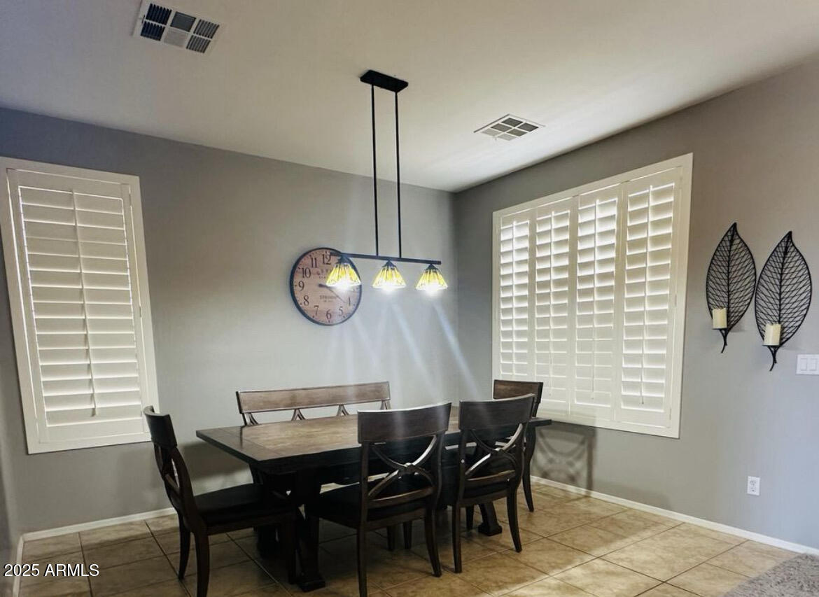 90 West Beechnut Place Chandler, AZ 85248 - Photo 6 of 32 a view of a dining room with furniture window and wooden floor