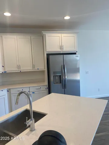a kitchen with a refrigerator and sink