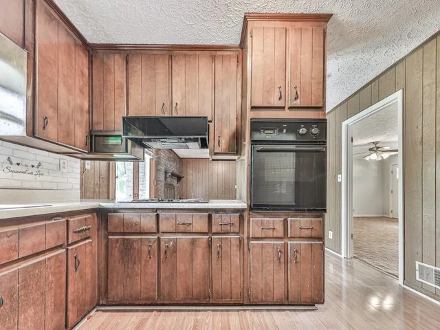 a kitchen with stainless steel appliances granite countertop a stove and cabinets