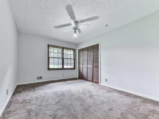 an empty room with a empty space and windows