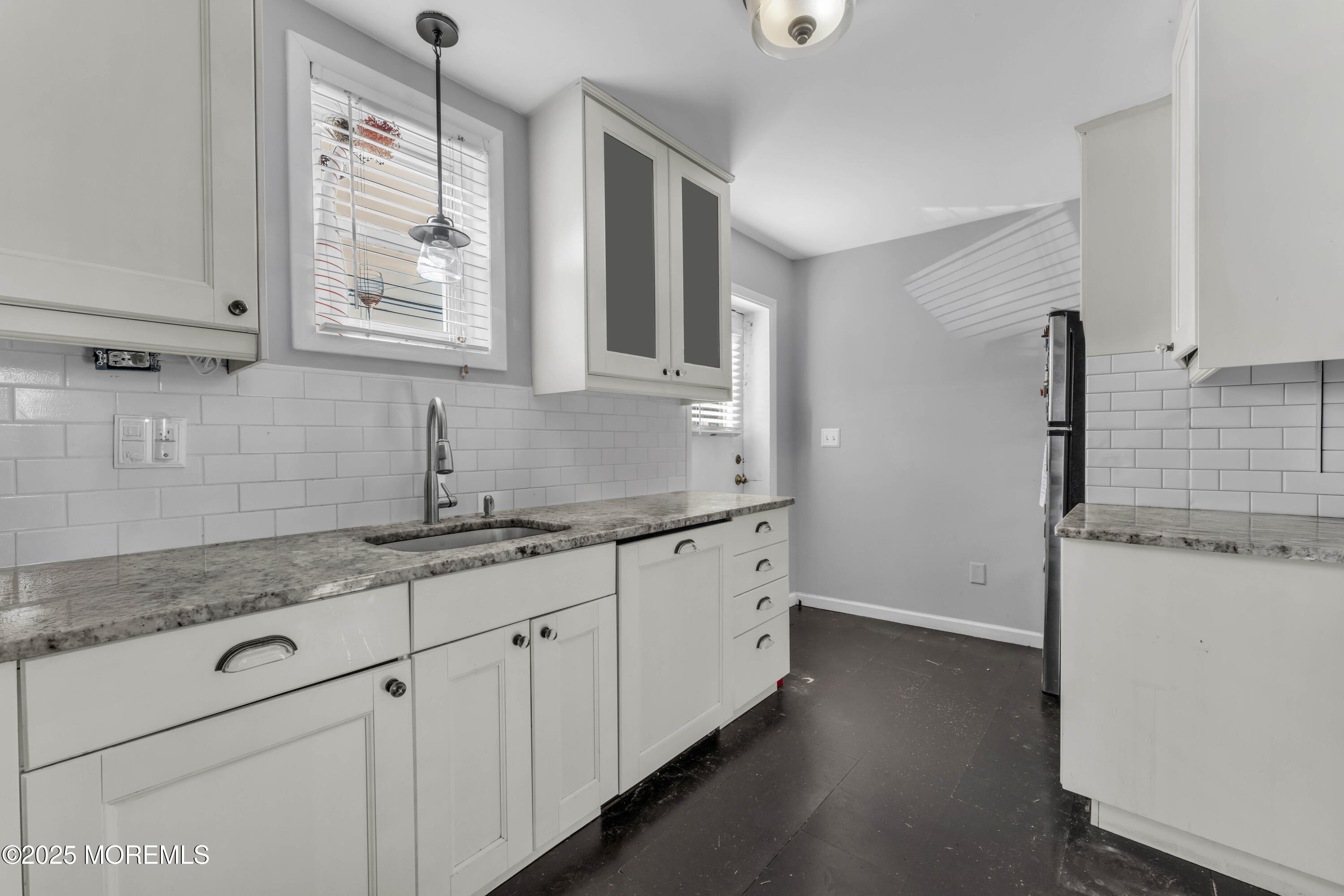 1217 Union Avenue Union Beach, NJ 07735 - Photo 8 of 26 a kitchen with granite countertop white cabinets and a sink