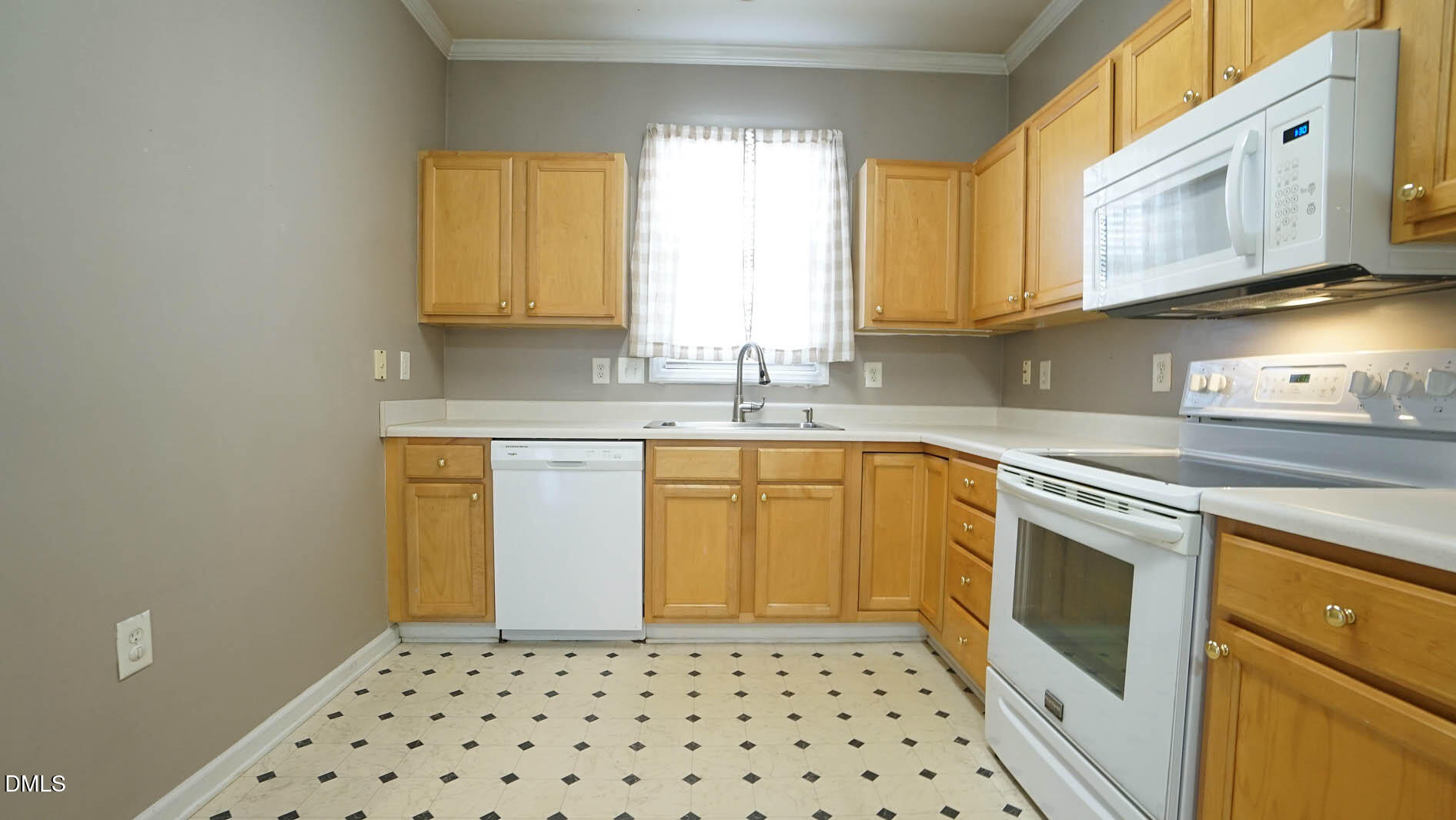 41 Signet Drive Durham, NC 27705 - Photo 9 of 34 a kitchen with a sink a stove cabinets and wooden floor