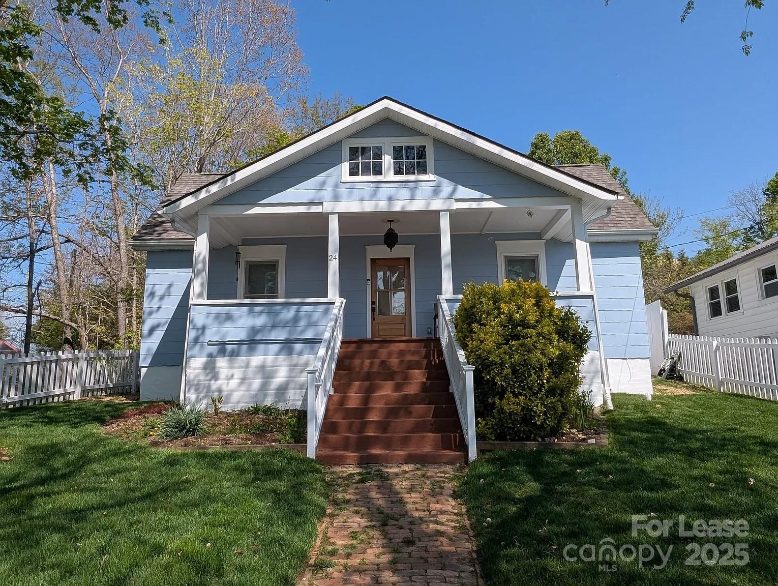 24 Woodrow Avenue Asheville, NC 28801 - Photo 1 of 30 a front view of a house with garden