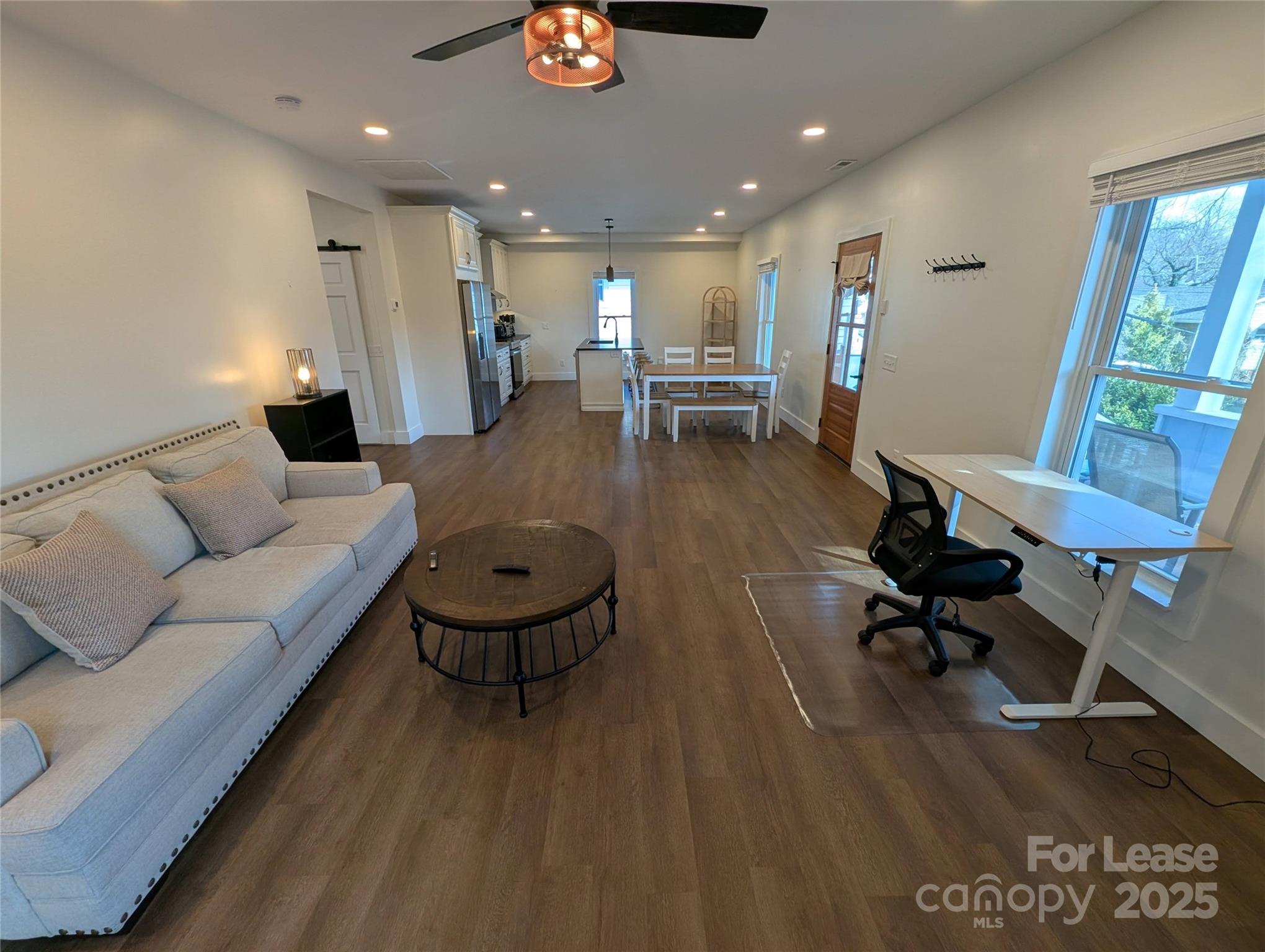 24 Woodrow Avenue Asheville, NC 28801 - Photo 12 of 30 a living room with furniture and a wooden floor