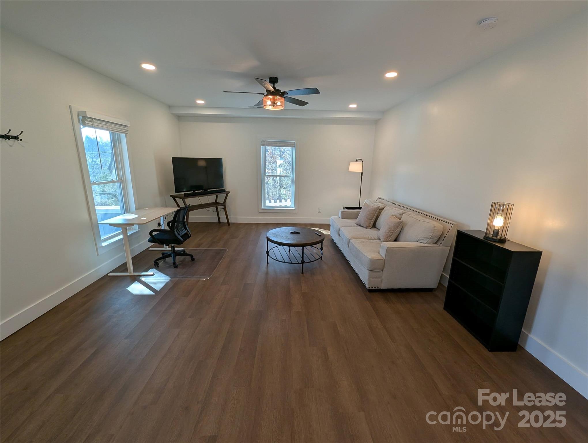 24 Woodrow Avenue Asheville, NC 28801 - Photo 13 of 30 a living room with furniture a flat screen tv and a wooden floor