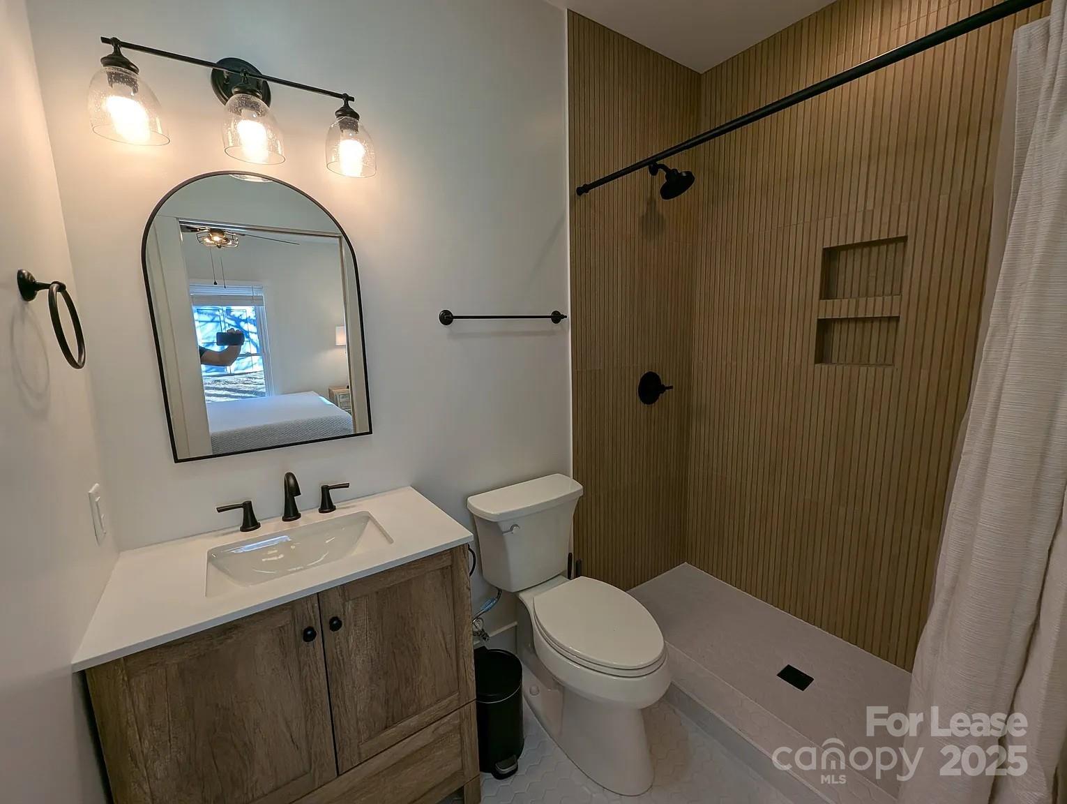 24 Woodrow Avenue Asheville, NC 28801 - Photo 15 of 30 a bathroom with a double vanity sink toilet and shower