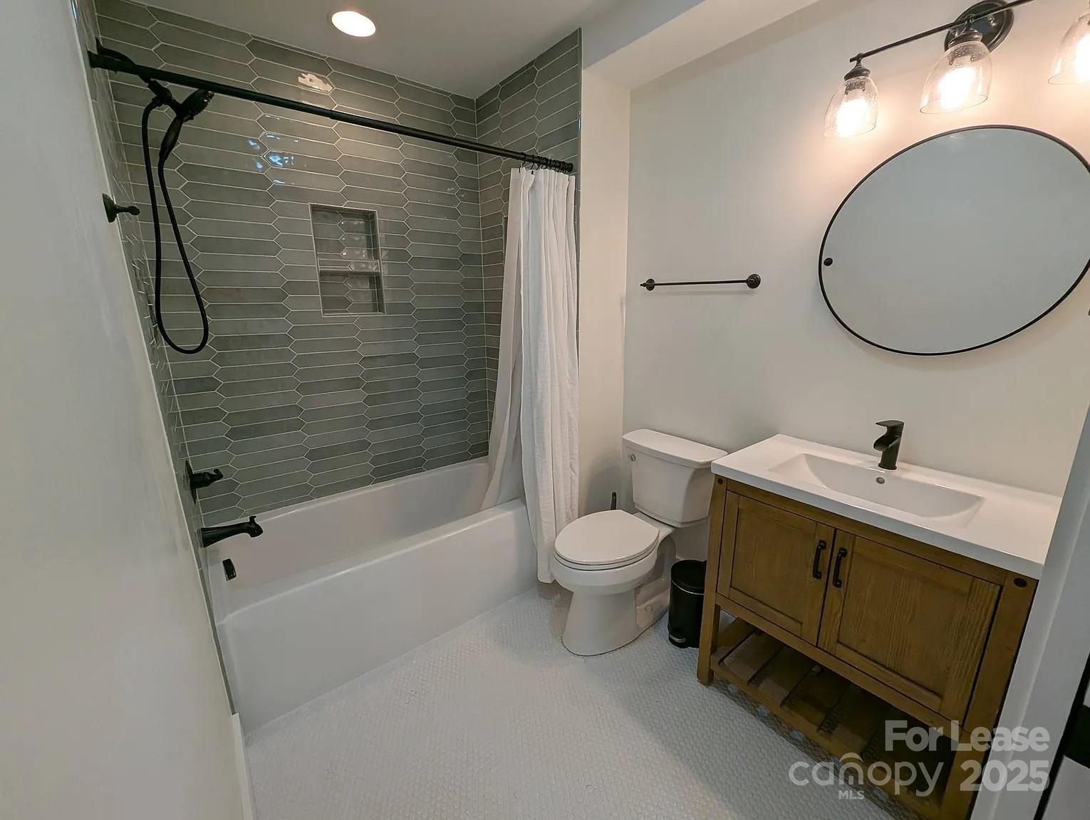 24 Woodrow Avenue Asheville, NC 28801 - Photo 16 of 30 a bathroom with a toilet sink and shower