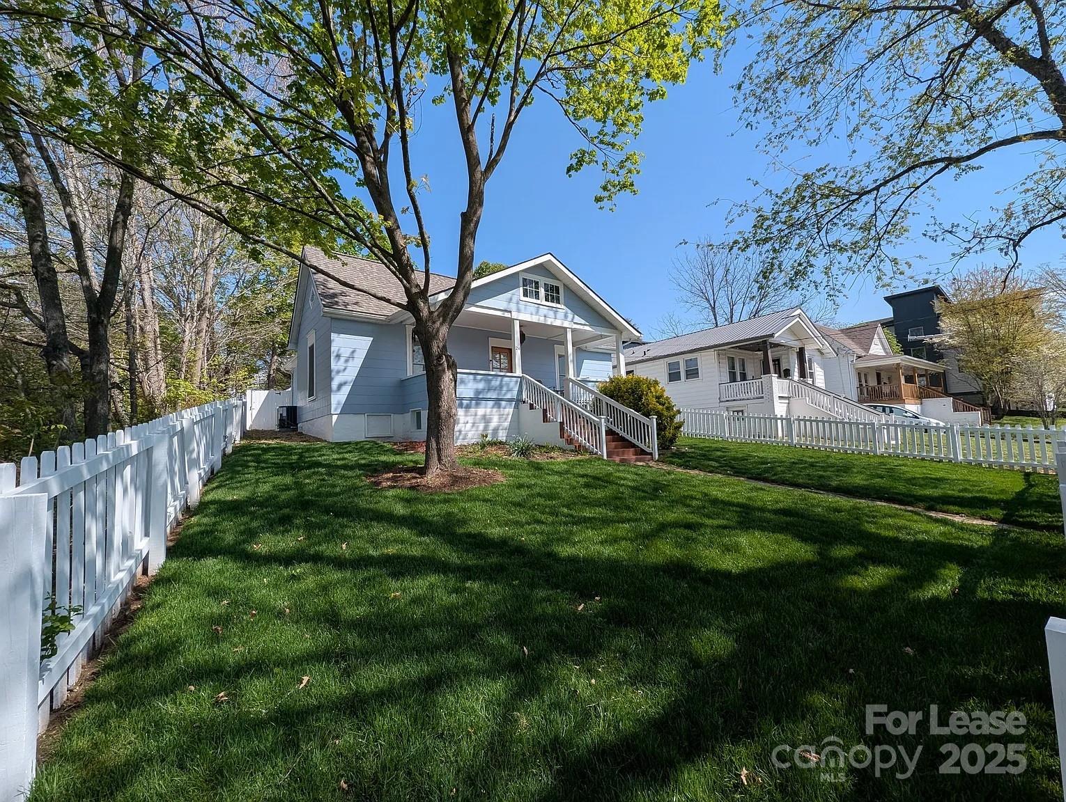 24 Woodrow Avenue Asheville, NC 28801 - Photo 26 of 30 a front view of a house with a yard