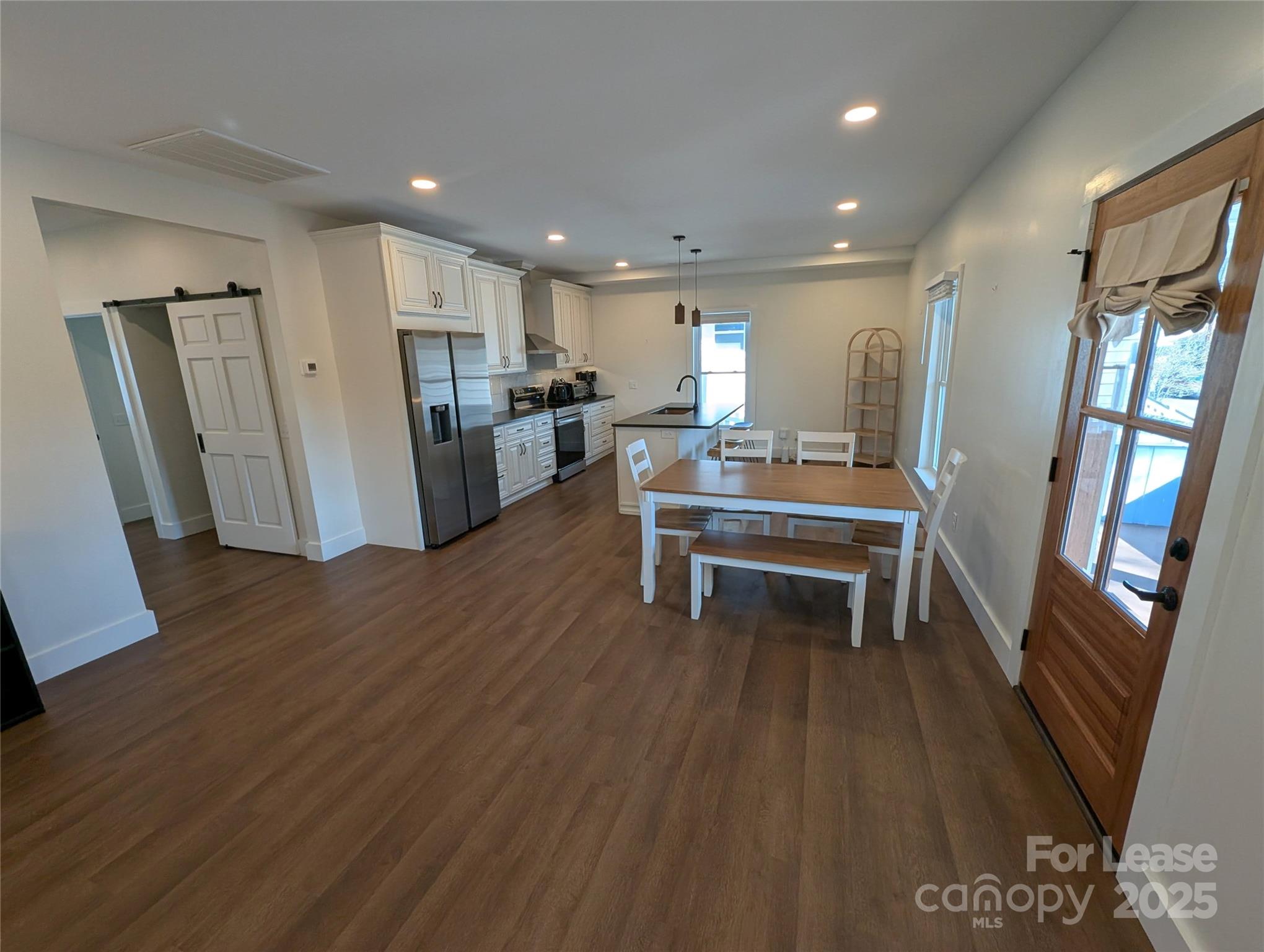 24 Woodrow Avenue Asheville, NC 28801 - Photo 5 of 30 a room with wooden floors and furniture