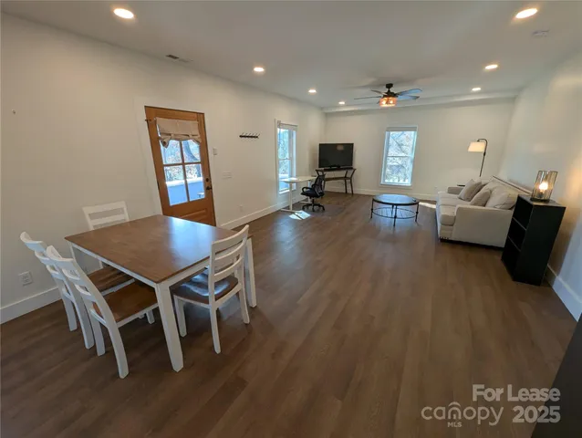 a view of a dining room with furniture and wooden floor