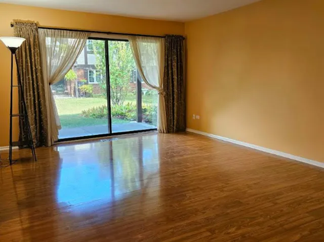 a dining room with furniture wooden floor a rug and a chandelier