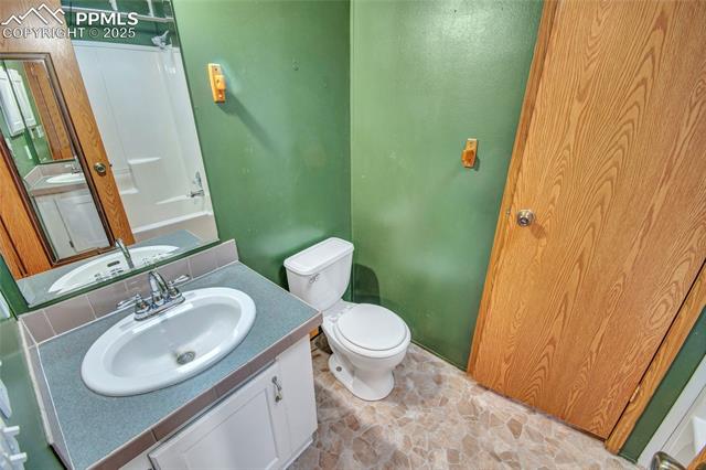 7940 Edison Road Yoder, CO 80864 - Photo 19 of 38 Full bath featuring vanity, shower / bath combination, and light stone finish floors