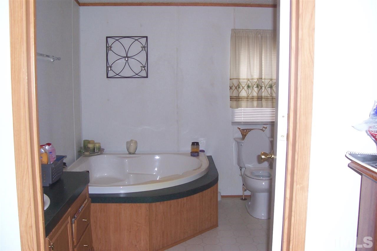10861 Claude Lewis Road Middlesex, NC 27557 - Photo 14 of 19 a bathroom with a sink and a mirror
