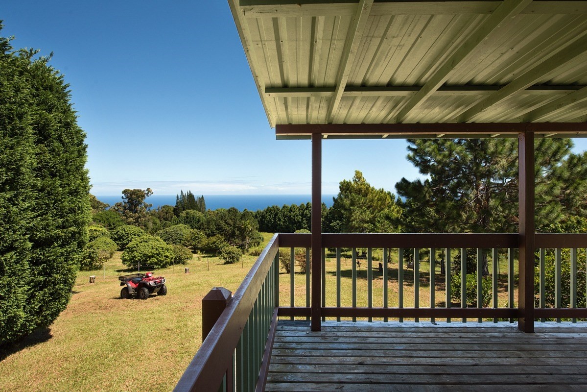 35-1625 Uweki Road Papaaloa, HI 96780 - Photo 12 of 20 a view of a balcony with wooden floor