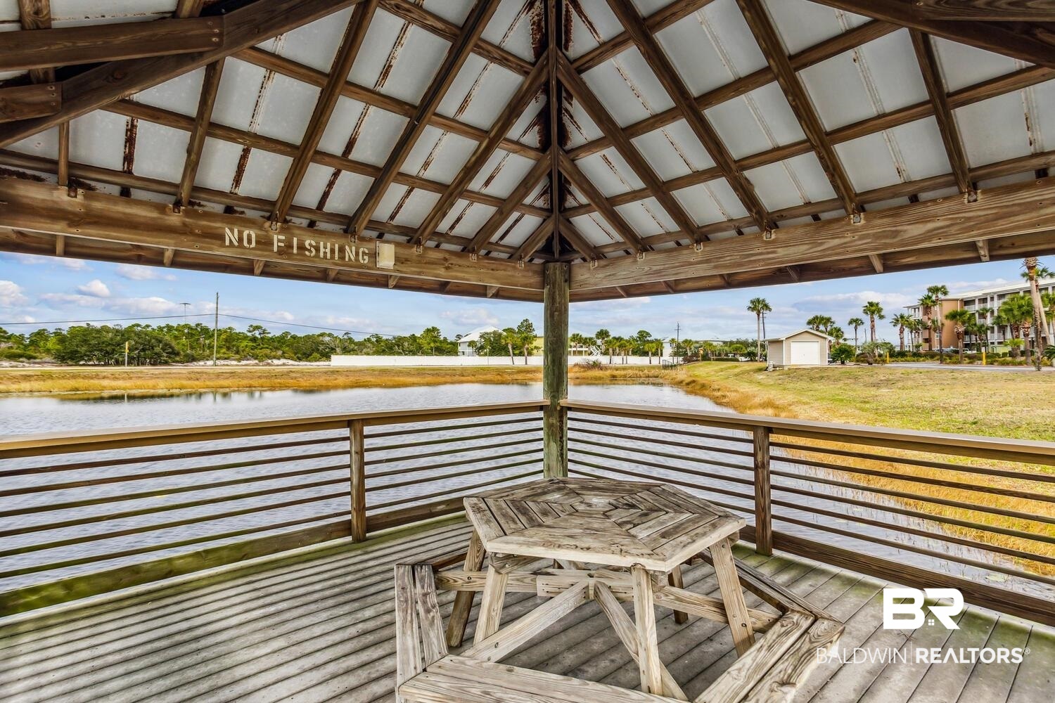 13551 Johnson Beach Road, Unit 112E Pensacola, FL 32507 - Photo 32 of 42 Dock area with a gazebo and a deck with water view