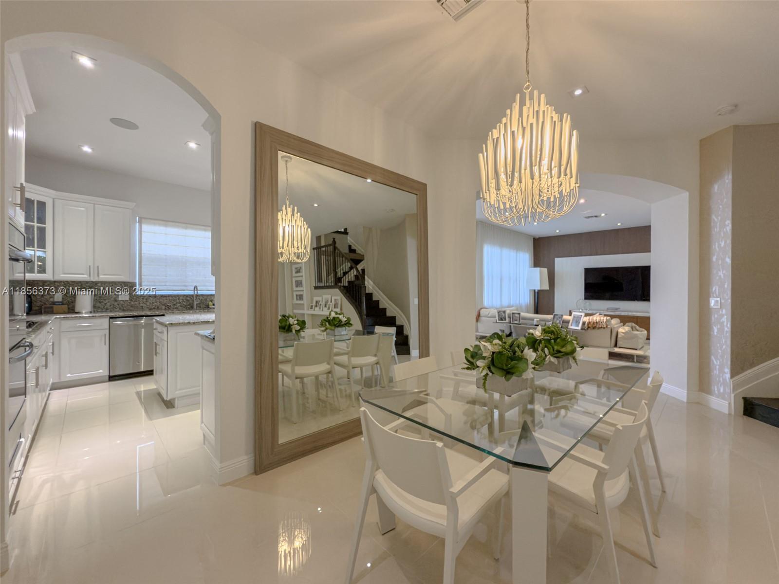 9709 Blue Isle Bay Parkland, FL 33076 - Photo 12 of 75 a view of a dining room kitchen and a chandelier fan fire place