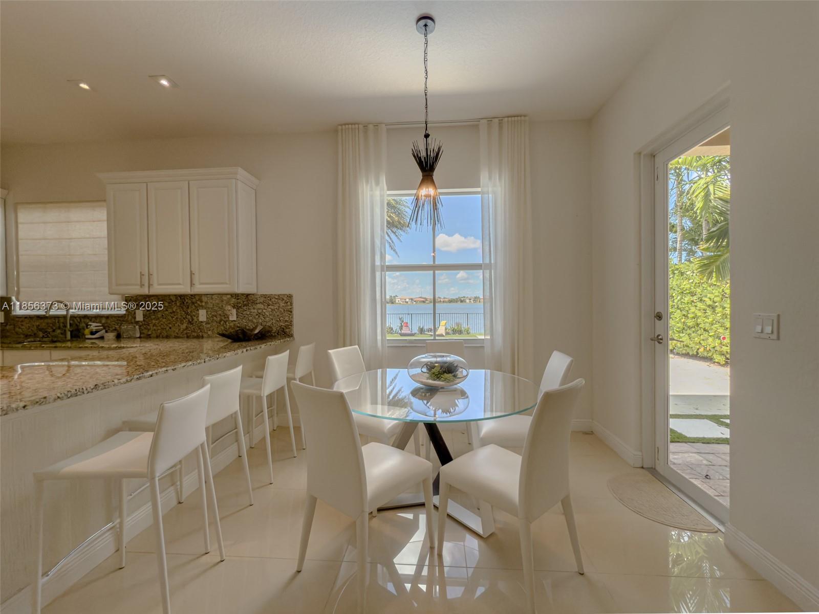 9709 Blue Isle Bay Parkland, FL 33076 - Photo 15 of 75 a dining room with furniture and window