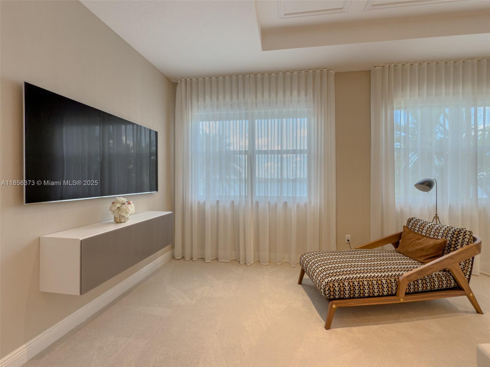 9709 Blue Isle Bay Parkland, FL 33076 - Photo 26 of 75 a living room with a couch and a flat screen tv